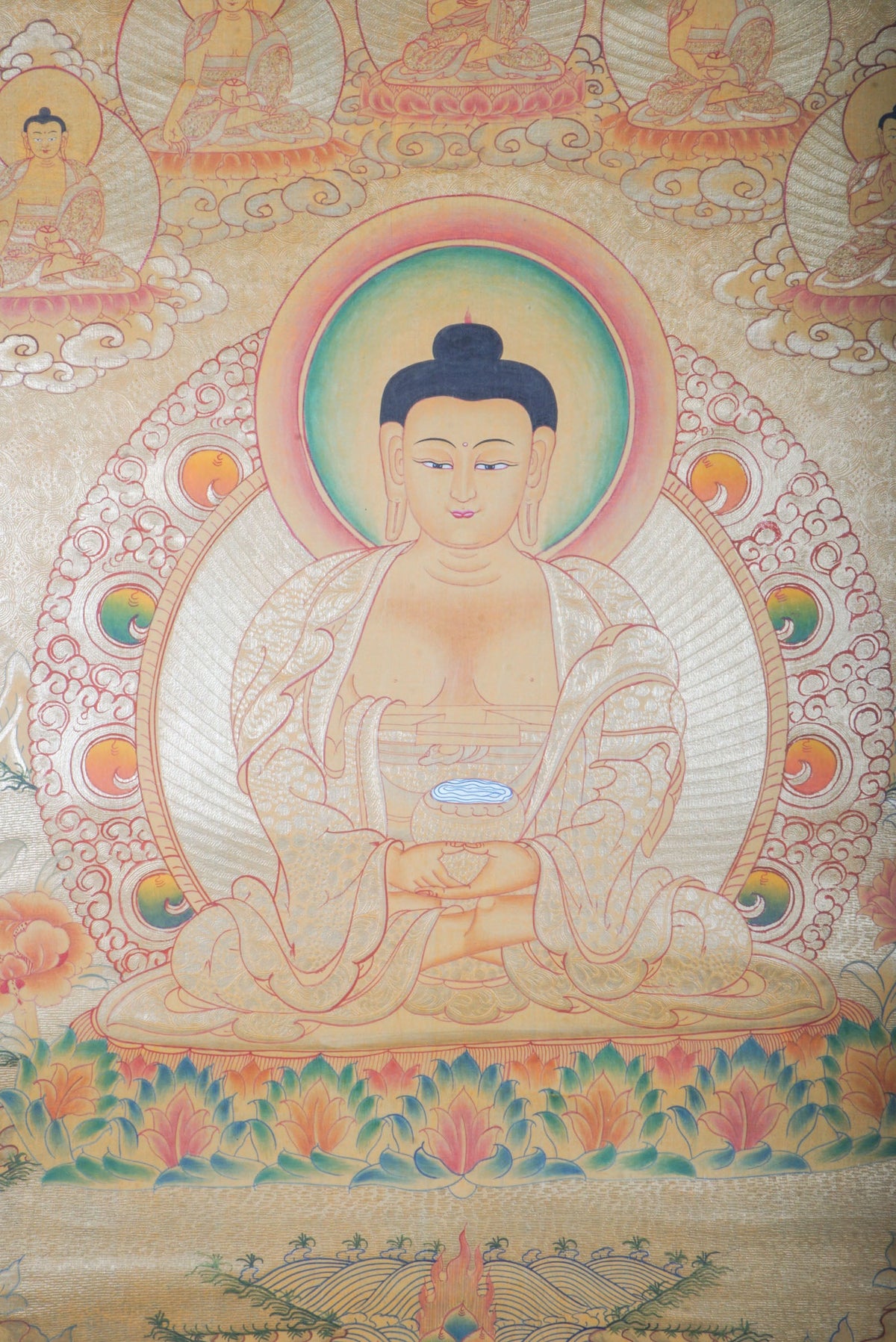 Hand-painted Tibetan Thangka of Amitabha Buddha on a gold background, the Buddha of Infinite Light seated in meditation holding a begging bowl, surrounded by celestial Buddhas, traditional Himalayan Buddhist art for Pure Land practice, meditation altar, and sacred wall decor.