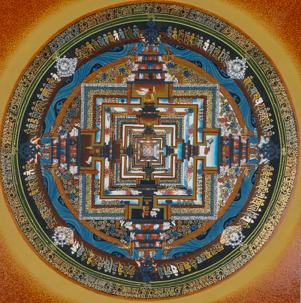Kalachakra Mandala thangka showing a circular mandala with a square central palace, layered gateways, concentric rings of Tibetan script, and an orange-gold background.