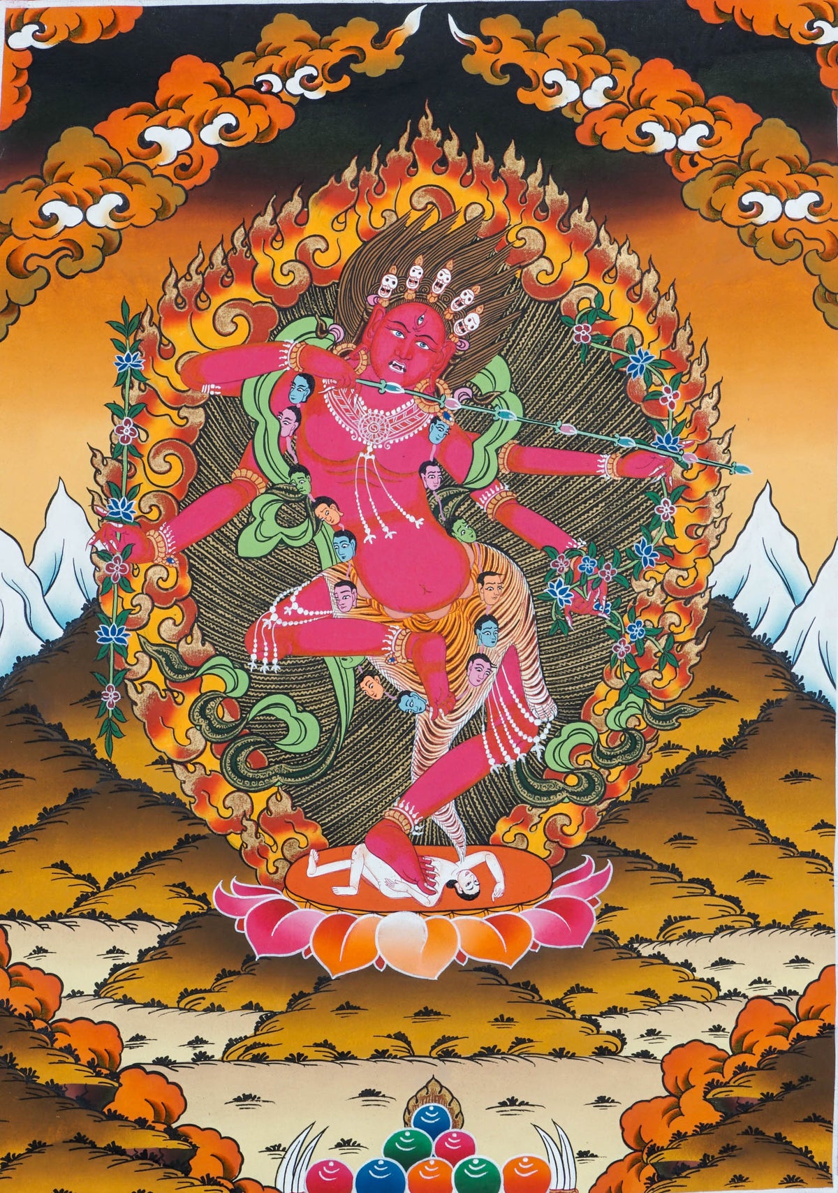 Traditional Tibetan thangka painting of Kurukulla, a red wrathful deity shown dancing on a lotus throne, surrounded by flames, clouds, and symbolic ornaments against a golden landscape background.