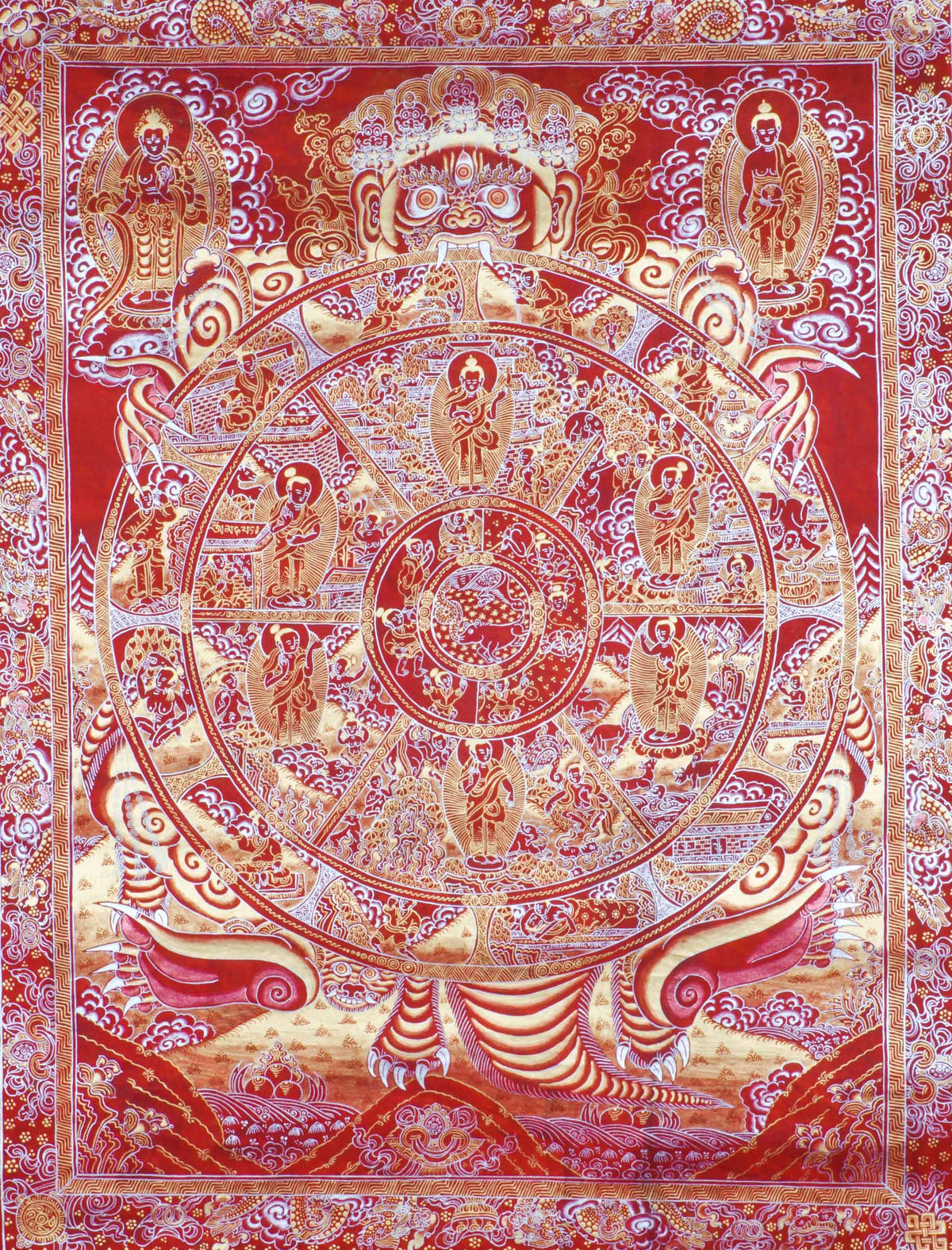 Red-toned thangka painting with gold and silver detailing, showing a large circular wheel divided into multiple sections filled with small human figures and scenes, held by a large multi-eyed figure at the top, surrounded by clouds, flames, and dense decorative patterns within a rectangular border.