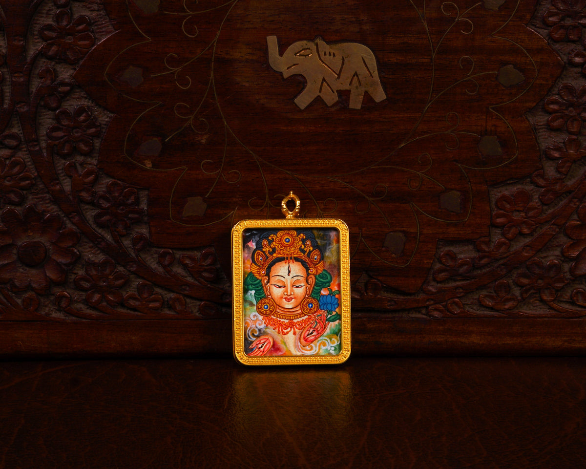 Newari White Tara Ghau pendant featuring a miniature Tibetan Buddhist goddess artwork in a decorative gold-tone frame handcrafted in Nepal.