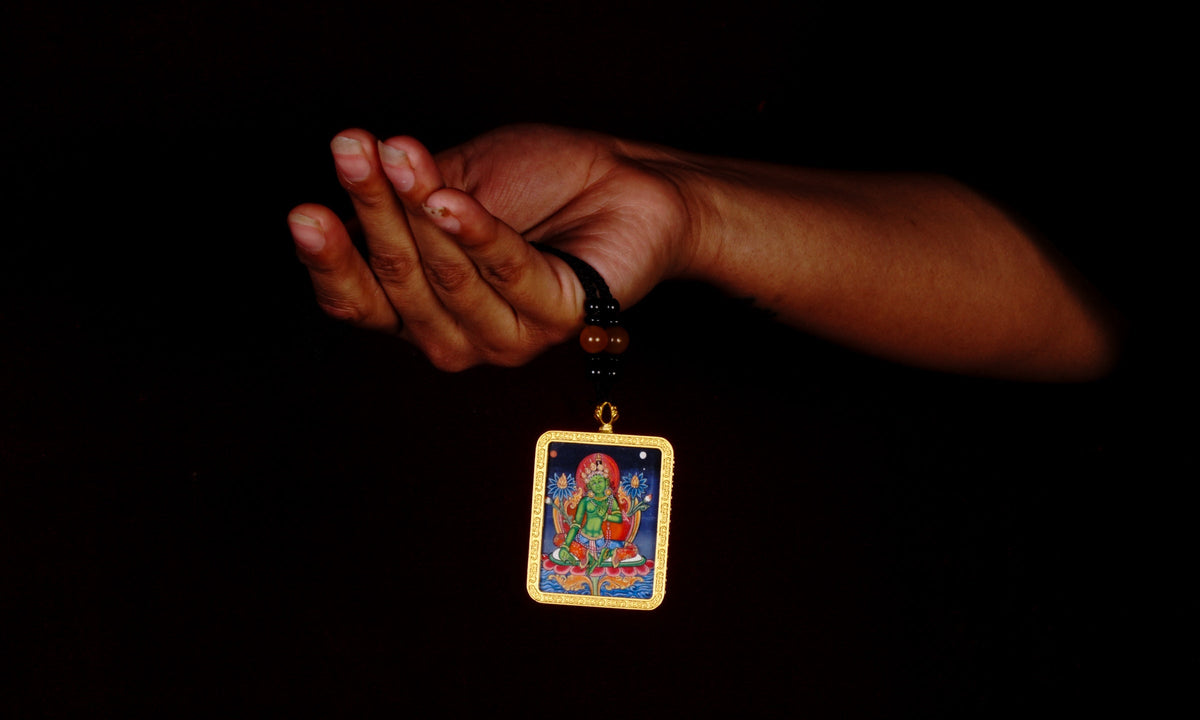 Hand-painted Green Tara miniature Thangka pendant in gold-accented copper Ghau locket with black beaded cord.