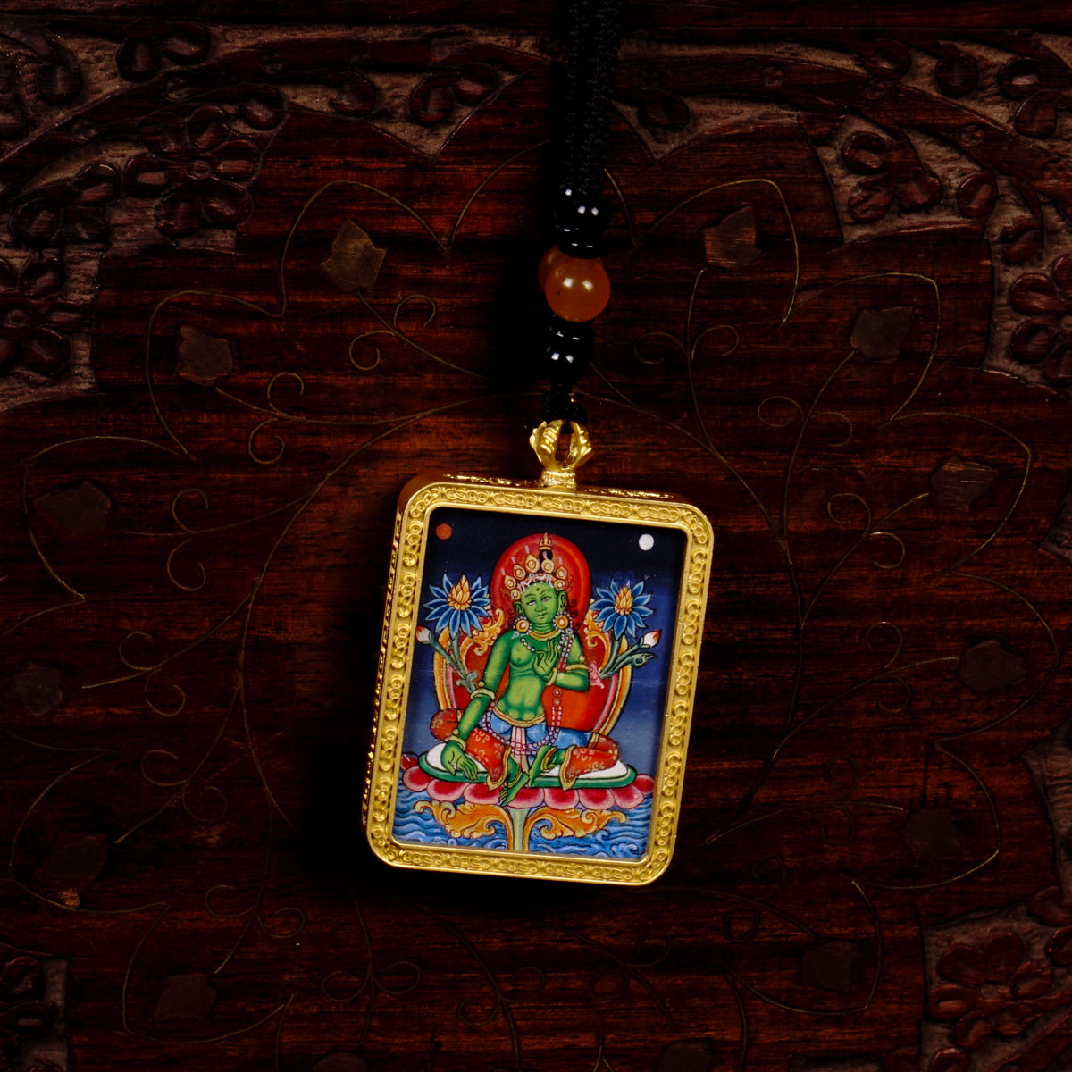 Hand-painted Green Tara miniature Thangka pendant in gold-accented copper Ghau locket with black beaded cord.