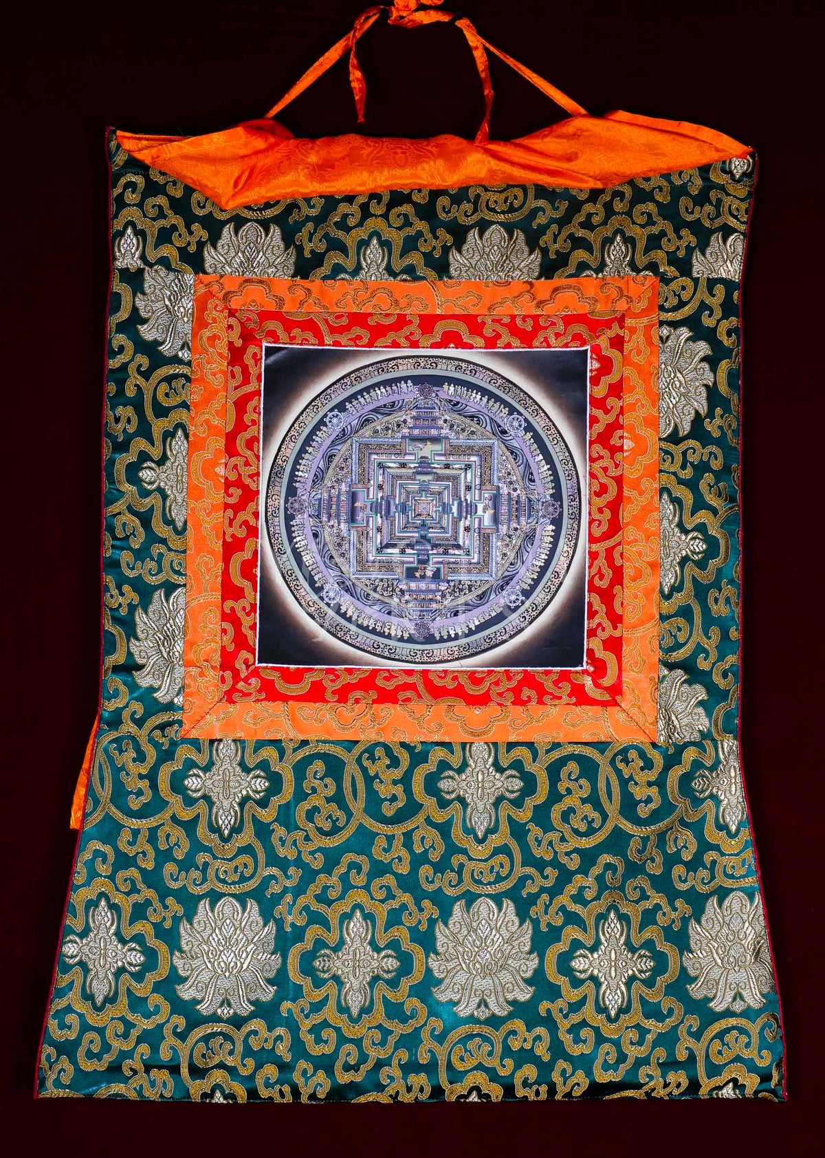Hand-painted Kalachakra Mandala Brocade Thangka mounted in traditional Tibetan silk brocade, handcrafted in Nepal and ready to hang for meditation, altar, and sacred wall décor.