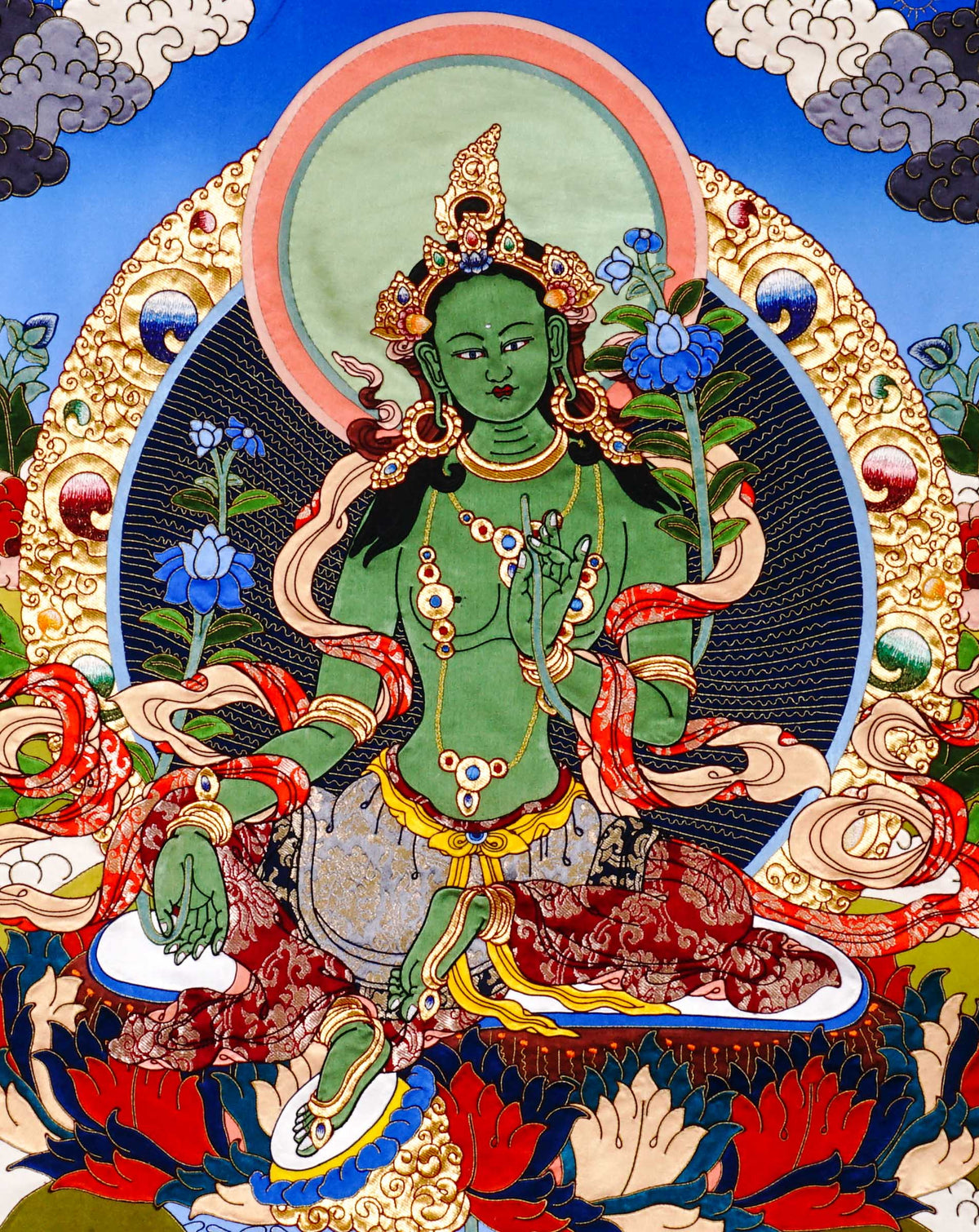 Green Tara cloth thangka printed on fabric showing Tibetan Buddhist goddess seated on lotus holding blue utpala lotus with vibrant halo background.