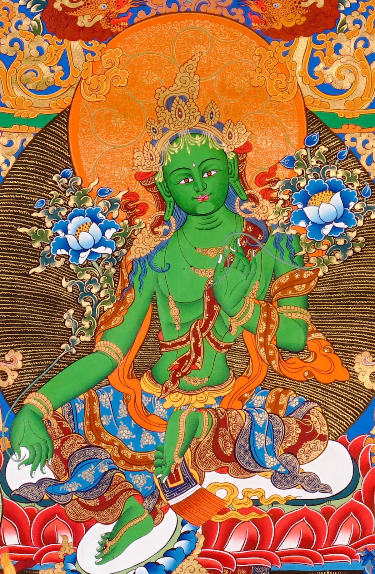 Hand-painted Green Tara thangka featuring the Tibetan Buddhist goddess seated on a lotus throne surrounded by sacred floral motifs and celestial symbolism