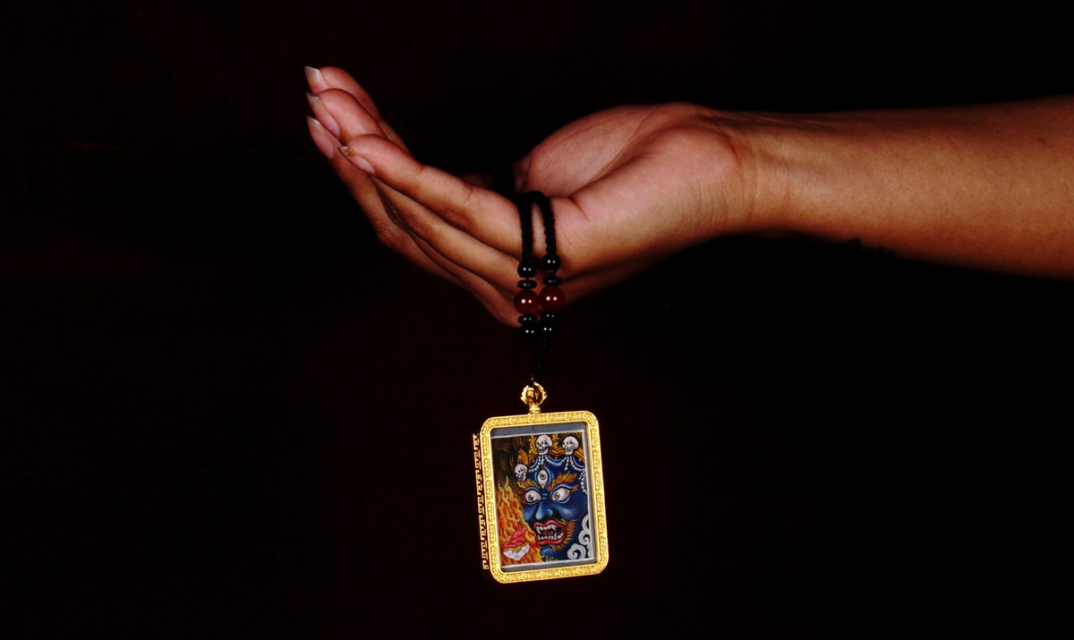 Hand-painted Mahakala miniature Thangka pendant in gold-accented copper Ghau locket with black beaded cord.