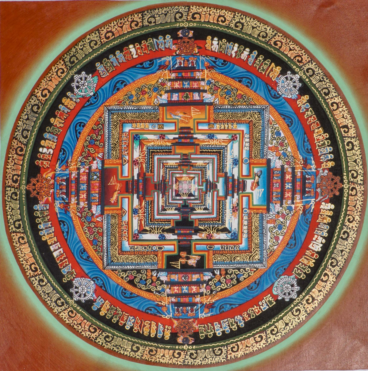 Kalachakra Mandala thangka showing a circular mandala with a square inner palace, layered gateways, concentric rings, and Tibetan script on a red background.